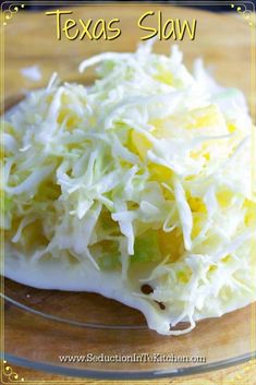 a close up of a plate of coleslaw on a wooden table with the words texas slaw above it