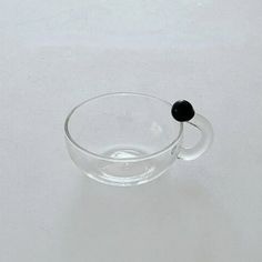 a glass bowl with a black object in it