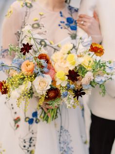 a bride and groom standing next to each other