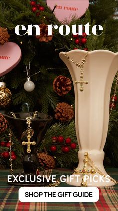 a white vase sitting next to a christmas tree