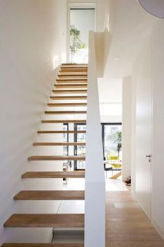 the stairs are made of wood and white