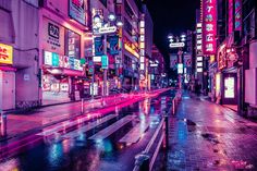 a city street filled with lots of neon lights