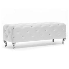 an upholstered bench with metal legs and buttons on the back, in white leather