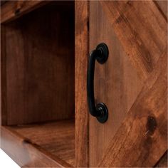 a wooden cabinet with black handles and knobs