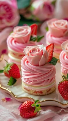 strawberry cupcakes with pink frosting and fresh strawberries on a platter