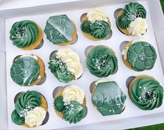 twelve cupcakes with green frosting in a box