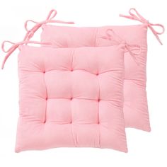 two pink cushions with ties on them