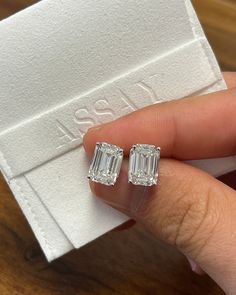 Introducing a perfect matching pair of 4-carat emerald cut diamond stud earrings. The fine jewelry gift of a lifetime.  Unisex lab-grown CVD diamond stud earrings. Emerald cut, 4 carats each, 4-prong basket set with pushback closure, and IGI certified.  Hypoallergenic, and waterproof. Ships overnight from Miami Florida.   Setting Details:  - Metal: 14K Gold  - Setting: 4-Prong - Style: Basket Diamond Details:  - Carat: 4.01 - Cut: Emerald - Clarity: VVS2 - Color: H - Measurements: 10.64 x 7.56 x Diamond Earrings In Box, Luxury Silver Earrings With Diamond Markers, Luxury Diamond Earrings With Square Cut, Luxury Baguette-cut Lab Grown Diamond Earrings, Luxury Emerald-cut Baguette Diamond Earrings, Luxury Classic Lab Grown Diamond Earrings, Luxury Baguette Cut Earrings For Engagement, Luxury White Gold Emerald Cut Diamond Earrings, Luxury Rectangular Earrings For Anniversary