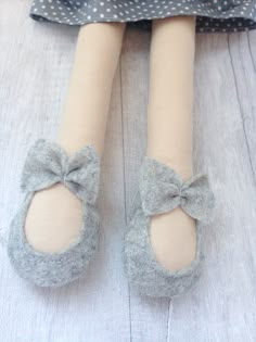 a close up of a doll's feet wearing slippers