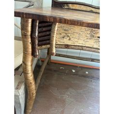 an old wooden table with two chairs behind it