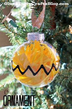 a glass ornament hanging from a christmas tree