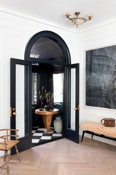 an entryway with black and white checkered flooring