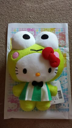 a hello kitty stuffed animal on top of a piece of paper