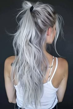 From the cute flowy silver ponytail you see here to messy updos and long loose waves, there are a ton of beautiful hairstyles for silver hair. Click through for 40+ hottest silver hair ideas and save your favorites! Silver Hair With Curtain Bangs, Silver Tipped Hair, Silver Blonde Hair Color Ideas, Bright Silver Hair, Light Colored Hair Ideas, Gray Blonde Hair Color, Platinum Blonde Hair With Roots, White Blonde Long Hair, White Hair Dark Roots