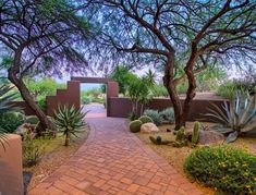 a pathway leading to an entrance into a desert garden