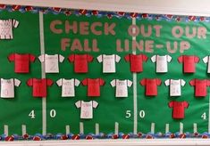 a bulletin board with red and white shirts on it that says check out our fall line - up