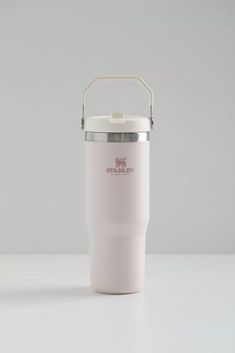 thermos cup with handle is sitting on a table