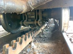 an old train track with some rust on the tracks and one piece of metal that has been placed under it