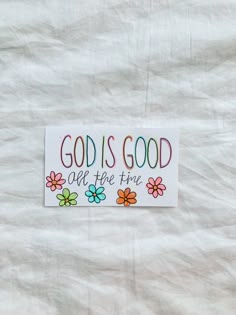 a sticker that says god is good all the time with flowers in it on a white background