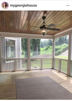 an empty porch with a ceiling fan and large rug on the floor in front of it