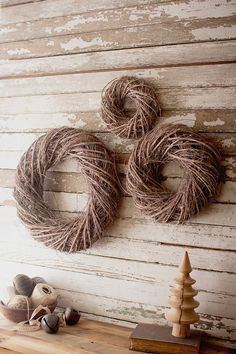 two twine wreaths are hanging on the wall