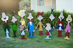 a group of cartoon characters standing in the grass