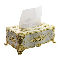 a tissue dispenser sitting on top of a white tablecloth covered box