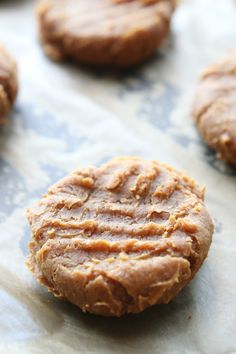 peanut butter cookies sitting on top of parchment paper