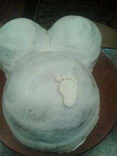 a cake with white frosting and ears shaped like an animal's paw on top