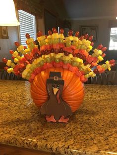 a turkey made out of candy sitting on top of a counter next to a lamp