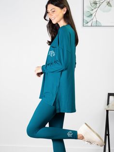 This set has us wanting to unwind and curl up with a good book on the weekend! It is the ultimate in comfort but stylish enough for a Target run. Features a monogram on the top and leggings. Only the monogram on the shirt can be previewed with our product personalizer. A matching monogram will be applied to the leggings. Top features a high/low hem with side slits for easy movement. Leggings run true to size, have stretch, and an elastic waist band. 90% Polyester, 10% Spandex Model is wearing a Target Run, Tunic Leggings, Leggings Set, Dark Teal, High Low Hem, Waist Band, The Weekend, High & Low, Good Books