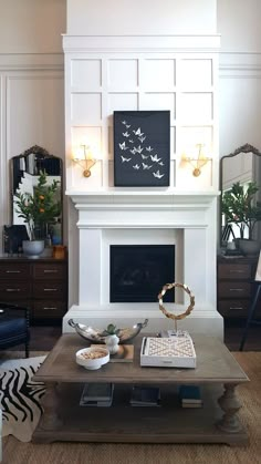 a living room filled with furniture and a fire place in front of a white fireplace