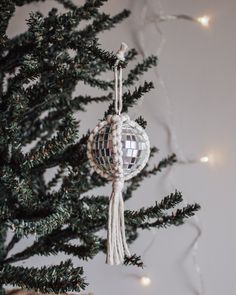 an ornament hanging from the top of a christmas tree