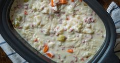 a casserole dish with carrots, celery and meat in it