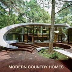 an unusual house in the woods surrounded by trees