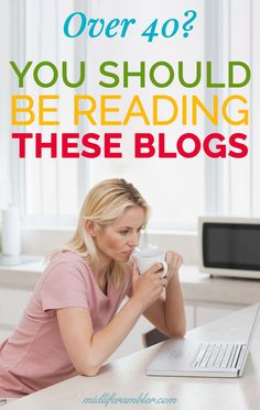 a woman sitting at a desk with a laptop and coffee mug in her hand, reading over 40 you should be reading these blogs