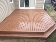 a wooden deck in front of a house