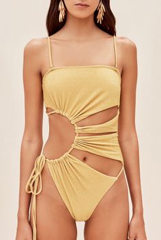 The Allegra one piece features signature Cult Gaia cutouts in a sunburst form. An adjustable tie at the right hip allows for secure fit. Shoulder straps are removable for customized wear. 10% of her fabric is composed of metallic paillettes to give some refined shine. She is slightly textured, which provides an effect of extra coverage. A gold-toned, brushed brass Cult Gaia logo can be found at the center back. 얼굴 그리기, Cut Out One Piece, Creation Couture, Cult Gaia, Cute Swimsuits, Womens Bathing Suits, One Piece Swimsuit, Bathing Suits, Champagne