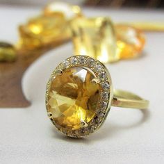 an oval shaped yellow sapphire and diamond ring