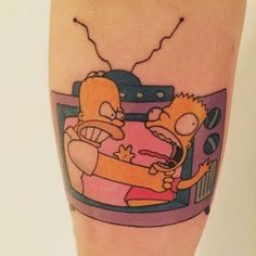 the simpsons tattoo on the leg of a person with a tv in front of them