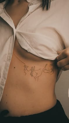 a woman is showing off her stomach with the outline of two birds on it's side