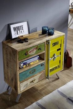 a small wooden cabinet with drawers on it's sides and an advertisement above the door