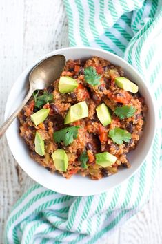 a white bowl filled with rice and topped with avocado