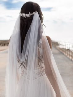 the back of a bride's dress, with her veil draped over her head