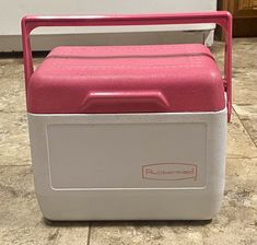 a red and white cooler sitting on the floor