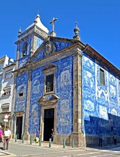 an old church with blue and white tiles on it