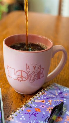 a cup of coffee being filled with liquid