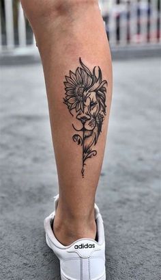 a woman's leg with a flower tattoo on the lower part of her leg