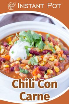 a bowl of chili con carne with sour cream on top and the words instant pot