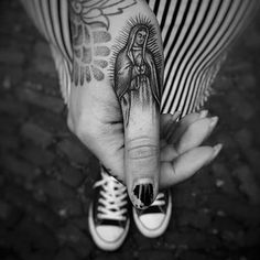 a woman's hand with a tattoo on it